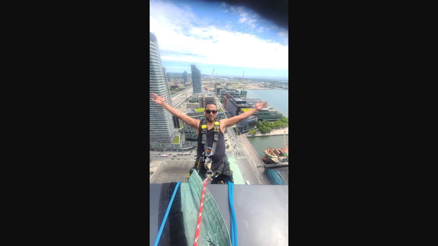 ClearGlass.ca team member at extreme height with city view