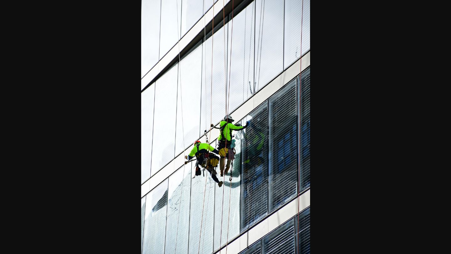 Window cleaners using proper safety equipment